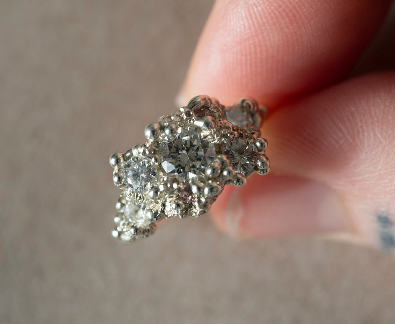 White gold bespoke ring held in hand
